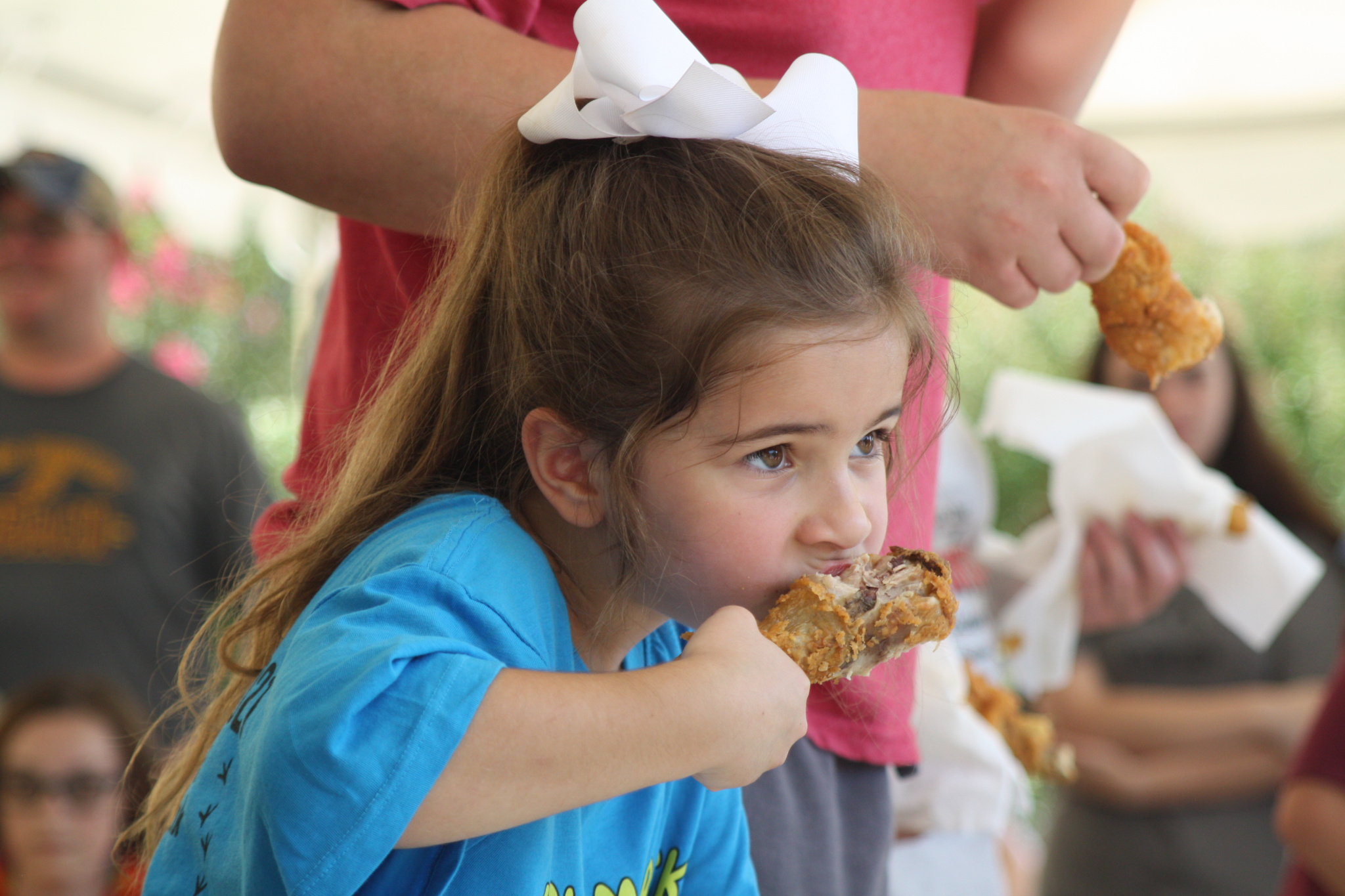 Olivia Williams, 6, in the drumstick eating contest