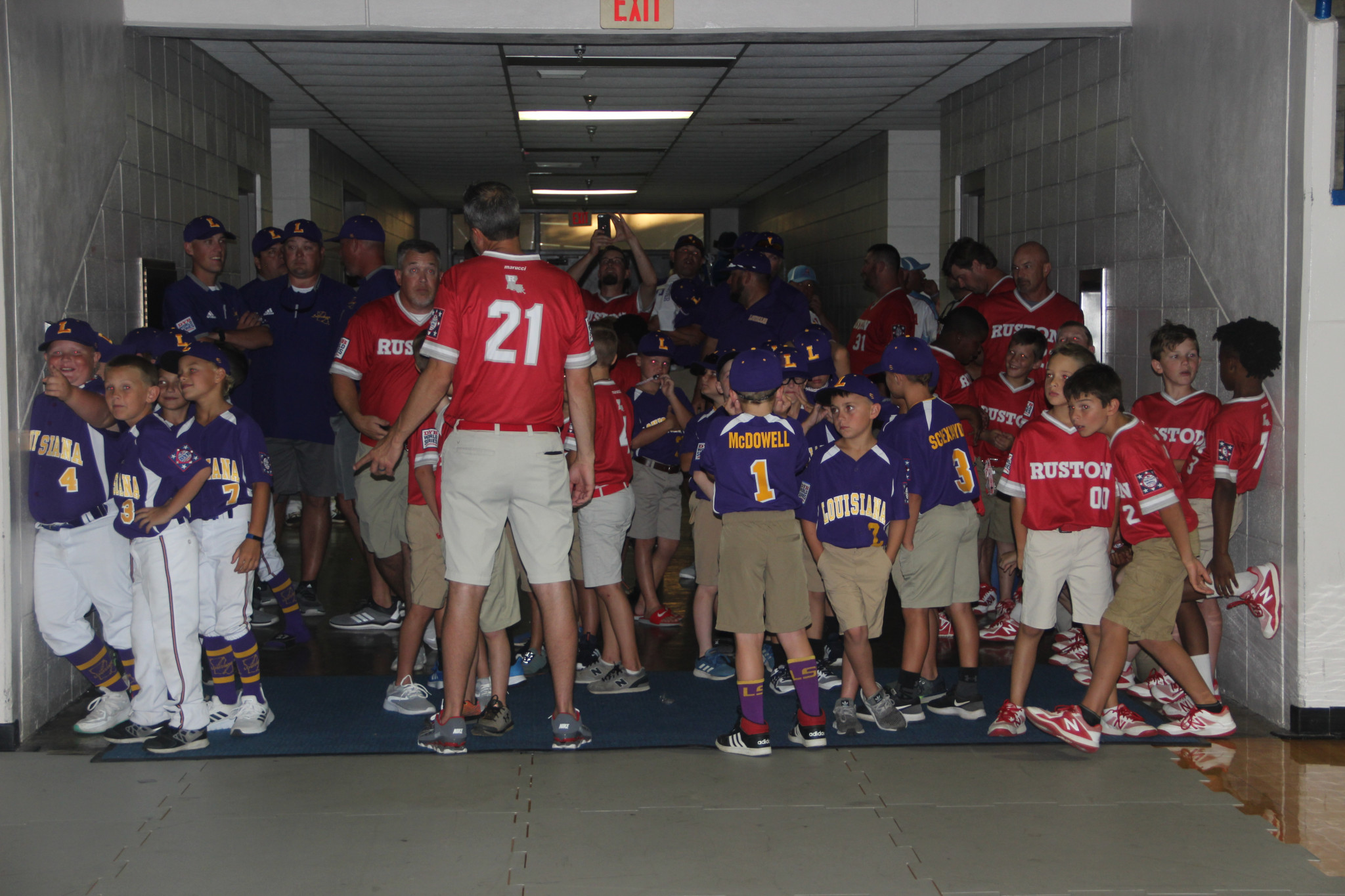 Team Louisiana (wearing purple) and Team Ruston (wearing red) wait for Friday’s opening ceremony to begin.