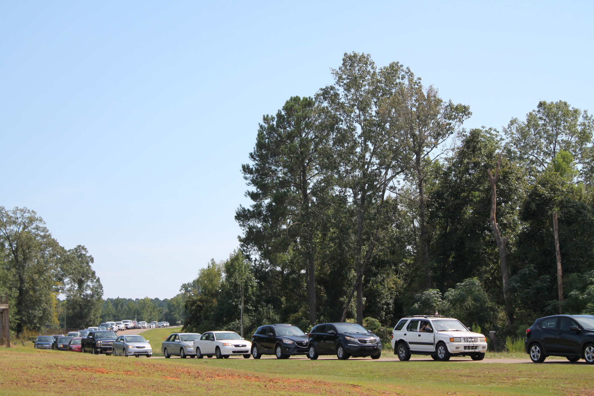 Cars lined up at the Expo Center to reeive food boxes and cases of water handed out by the Louisiana National Guard.